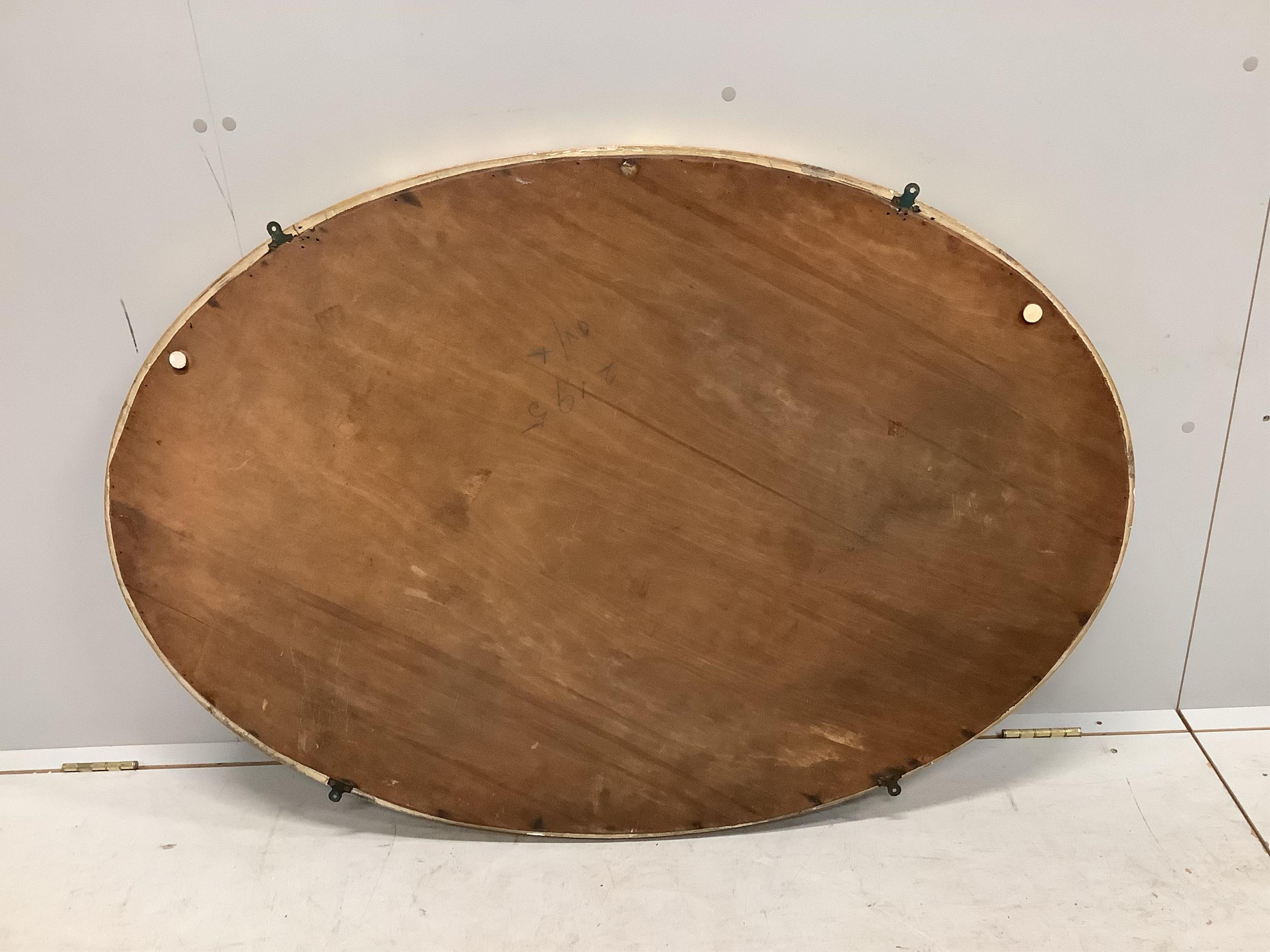 A George III style oval giltwood and composition marginal plate wall mirror, width 124cm, height 86cm. Condition - fair to good, plate spotted